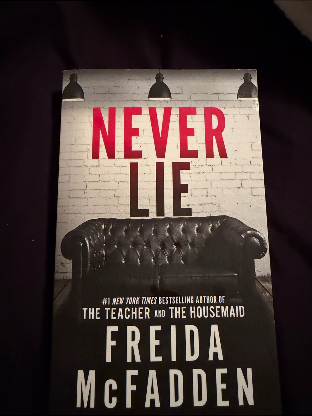 Never Lie by Freida McFadden — Black, White & Red Paperback